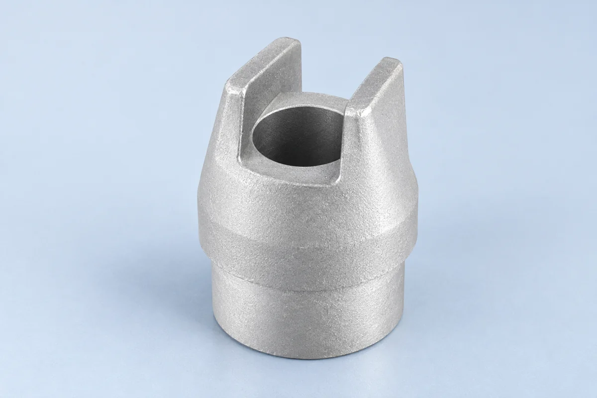 Forked cylindrical casting with two tall parallel prongs above a round base